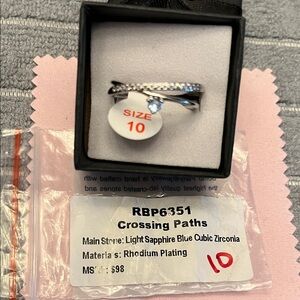 Crossing Paths Rhodium Plated Ring with Light Sapphire Blue Cubic Zirconia